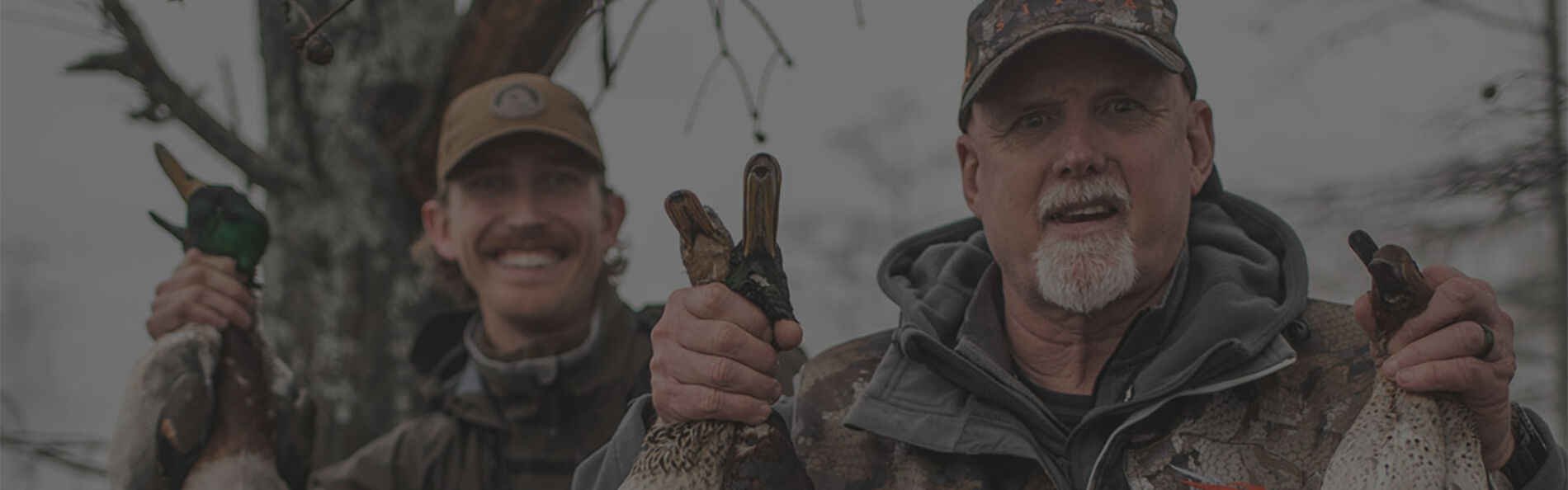 Seth Dortch holding up ducks