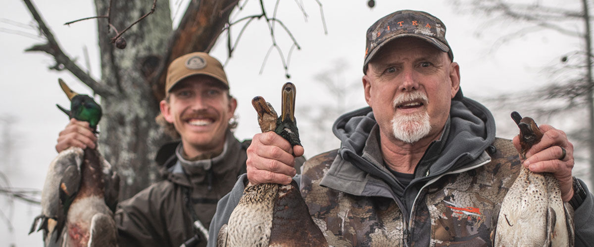 Seth Dortch holding up ducks