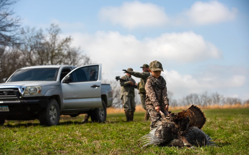 Cash pulling his turkey toward a pickup truck